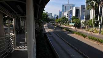 Suasana lengang di Jalan H. R. Rasuna Said, Kuningan Jakarta, Rabu (9/4). Hari ini Masyarakat seluruh Indonesia melaksanakan pencoblosan Pemilu Legislatif 2014. [suara.com/Adrian Mahakam]