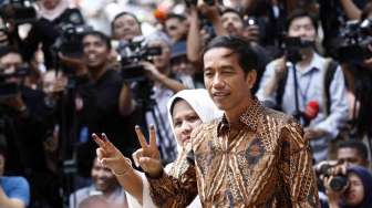 Calon Presiden nomor urut 2, Joko Widodo beserta Istri mencoblos di TPS 18 Kelurahan Menteng yang terletak di Taman Surapati Jakarta, Rabu (9/7). [suara.com/Adrian Mahakam]