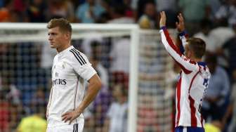 Gelandang Real Madrid Toni Kroos (kiri) tampak terdiam, sedangkan pemain Atletico Madrid Antoine Griezman merayakan kemenangan timnya di Santiago Bernabeu. REUTERS/Sergio Perez