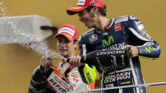 Selebrasi juara dua Moto GP Spanyol, Valentino Rossi dan juara ketiga Dani Pedrosa usai balapan di Sirkuit Ricardo Tormo, Valencia Spanyol, (9/11). (Reuters/Heino Kalis)