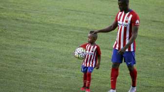 Striker baru Atletico Jackson Martinez bersama anaknya saat diperkenalkan ke publik. Reuters/Susana Vera