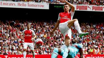 Pemain West Ham West Diafra Sakho mencoba menghalangi pemain Arsenal Laurent Koscielny menenang bola. Reuters / Eddie Keogh