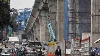 Sejumlah pekerja menyelesaikan proyek jalan layang Transjakarta Koridor XIII jalur Tendean-Blok M-Ciledug di Jalan Trunojoyo, Jakarta, Selasa (31/5/2016). [Suara.com/Kurniawan Mas'ud]