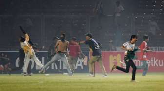 Suporter Persija Jakarta melempari petugas kepolisian ketika terlibat kericuhan pada laga TSC 2016 di Stadion Utama Gelora Bung Karno, Jakarta, Jumat (24/6/2016) [Antara/Wahyu Putro A]