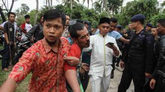 Petugas kepolisian berpakaian sipil dibantu warga menangkap tahanan yang kabur dari Rutan Sialang Bungkuk Kelas IIB, Pekanbaru, Riau, Jumat (5/5).