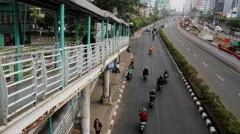 Pengendara sepeda motor melintas di Jalan HR Rasuna Said, Kuningan, Jakarta, Sabtu (26/8).