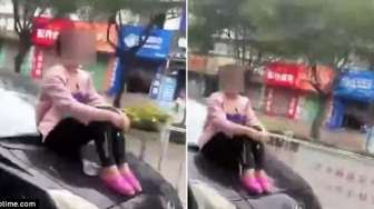 Suami Mau Kabur, Perempuan Ini Nekat Duduki Kap Mobil yang Melaju