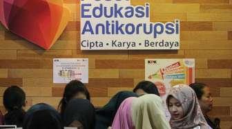 Pengunjung melihat-lihat buku dan bahan informasi yang dipajang di stan KPK pada pameran Indonesia International Book Fair (IIBF) 2017 di Jakarta Convention Center (JCC), Sabtu (9/9/2017). [Suara.com/Oke Atmaja]
