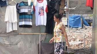 Warga beraktivitas di depan rumah semi permanen di Kampung Akuarium, Jakarta Utara, Selasa (24/10).