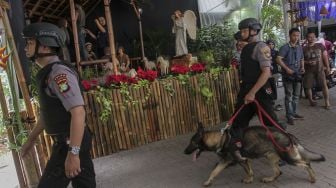 Personel Gegana dan anjing pelajak Mabes Polri melakukan penyisiran dalam operasi sterilisasi Gereja Katedral, di Jakarta, Minggu (24/12/2017).