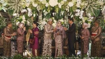 Presiden Joko Widodo didampingi Ibu Negara Iriana Joko Widodo memberikan ucapan selamat kepada Anisa Firdia Hanum, putri dari Mensesneg Pratikno saat resepsi pernikahan di Jogja Expo Centre, DI Yogyakarta, Sabtu (30/12).