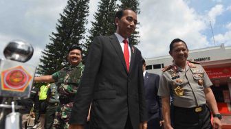 Presiden Joko Widodo (tengah) didampingi Panglima TNI Marsekal TNI Hadi Tjahjanto (kiri) dan Kapolri Jenderal Pol Tito Karnavian (kanan) meninggalkan ruangan seusai memberikan pembekalan pada Rapat Pimpinan (Rapim) TNI-Polri di Mabes TNI Cilangkap, Jakarta, Selasa (23/1).