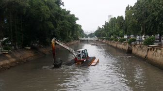 Pengerukan lumpur di aliran anak kali Ciliwung, Pasar Baru, Jakarta, Senin (19/2). 