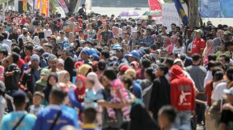 Warga memadati kawasan Festival Danau Sunter yang digelar di Jakarta, Minggu (25/2/2018). Festival yang baru pertama kali digelar tersebut diisi dengan beragam rangkaian acara seperti eksebisi olah raga, kesenian tradisional hingga bazaar. [suara.com/Kurniawan Mas'ud]