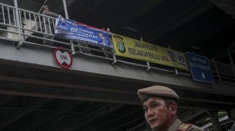 Petugas Satpol PP bersama dengan petugas Bawaslu menertibkan sejumlah spanduk dan atribut partai politik yang dipasang di sepanjang Jalan Letjen Suprapto dan Ahmad Yani, Cempaka Putih, Jakarta, Rabu (21/3). 