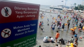 Pengunjung memadati Pantai Karnaval Ancol, Jakarta, Selasa (19/6). 