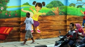 Sejumlah warga tampak melintas di samping beberapa lukisan mural tiga dimensi di kawasan Jatinegara, Jakarta, Jumat (6/7/2018). [Suara.com/Muhaimin A Untung]