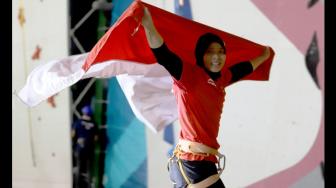 Atlet panjat tebing Indonesia, Aries Susanti Rahayu, melakukan selebrasi setelah memenangi final kategori speed putri Asian Games 2018 di Arena Panjat Tebing Jakabaring Sport City (JSC), Palembang, Kamis (23/8/2018). [Antara/INASGOC/Hendra Nurdiyansyah]