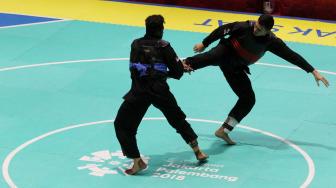 Aji Bangkit Pamungkas mendapatkan medali emas usai mengalahkan pesilat Singapura Sheik Ferdous Sheik Alauddin dalam babak final Kelas I Putra Asian Games 2018.[Suara.com/Oke Dwi Atmaja]