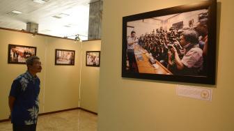Pengunjung melihat foto pameran foto jurnalistik Warna-Warni Parlemen Moderen di Gedung Parlemen, Jakarta, Kamis (30/8). [Suara.com/Muhaimin A Untung]