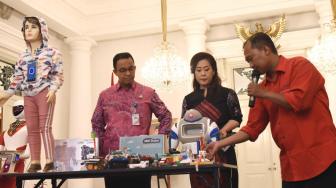 Gubernur DKI Jakarta Anies Baswedan mendengarkan penjelasan dari anggota  Yayasan Pendidikan Robotik Indonesia Wahidin usai penandatanganan kerjasama di ruang Balairung, Balai Kota, Jakarta Pusat, Kamis (11/10). (Suara.com/Fakhri Hermansyah) 