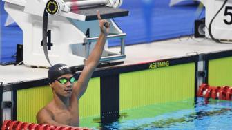 Perenang Indonesia Jendi Pangabean berselebrasi usai finish terdepan dalam nomor renang 100 meter gaya punggung putra S9 Asian Para Games 2018 di Stadion Akuatik, Senayan, Jakarta, Kamis (11/10). [ANTARA FOTO/Akbar Nugroho Gumay]