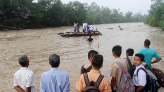 Sejumlah pelajar menggunakan perahu getek untuk menyeberang sungai Batang Batahan di Jorong Lubuk Gobing, Nagari Silaping, Kecamatan Ranah Batahan, Kabupaten Pasaman Barat, Sumatera Barat, Rabu (17/10). [ANTARA FOTO/Muhammad Arif Pribadi]