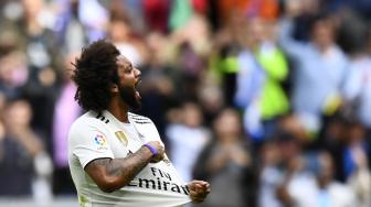 
Bek Brasil Real Madrid Marcelo merayakan golnya setelah mencetak gol ke gawang Levante selama pertandingan sepak bola liga Spanyol Real Madrid melawan Levante di Stadion Santiago Bernabeu, Madrid, Spanyol, Sabtu (20/10). [AFP/GABRIEL BOUYS]