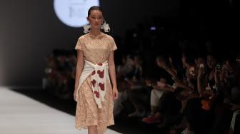 Model mengenakan pakaian rancangan desainer Didiet Maulana dari IKAT Indonesia saat peragaan busana Disney's Mickey Mouse: The True Orginal di Jakarta Fashion Week 2019 di Senayan City, Jakarta, Senin (22/10). [Suara.com/Muhaimin A Untung]