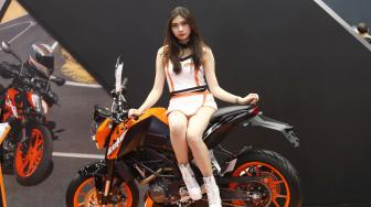 Sales Promotion Girls (SPG) atau model bersanding di samping motor pada pembukaan Indonesia Motorcycle Show (IMOS)2018 diikuti sejumlah produsen kendaraan  2018, JCC Senayan,  Jakarta, Rabu (31/10). [Suara.com/Muhaimin A Untung] 