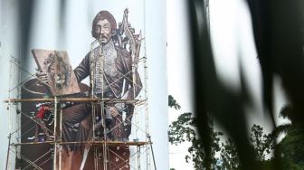 Seniman melukis tokoh Raden Saleh di Gedung Taman Ismail Marzuki, Jakarta, Senin (12/10). [Suara.com/Muhaimin A Untung]