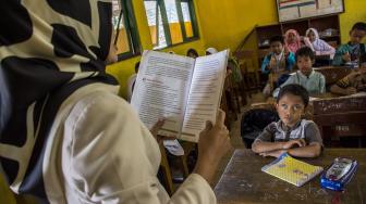 Muhklis Abdul Kholik (tengah), berpamitan pulang seusai belajar di SDN 10 Sekarwangi, Cibadak, Kabupaten Sukabumi, Jawa Barat, Jumat (16/11). [ANTARA FOTO/Nurul Ramadhan]