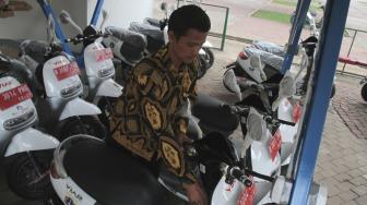 Petugas melakukan uji coba motor listrik untuk operasional petugas pengamanan di Monumen Nasional, Jakarta Pusat, Sabtu (15/12). [Suara.com/Fakhri Hermansyah]