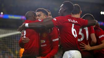 Pemain tengah Manchester United Jesse Lingard merayakan golnya dengan rekan satu timnya setelah mencetak gol keempat mereka dari titik penalti selama pertandingan sepak bola Liga Inggris antara Cardiff City melawan Manchester United di Stadion Cardiff, Cardiff, Inggris, Minggu (23/12). [Geoff CADDICK / AFP]