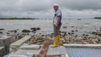 Warga berdiri di atas bekas rumahnya yang hancur diterjang gelombang tsunami Selat Sunda di Kecamatan Sumur, Pandeglang, Banten, Selasa (25/12). ANTARA FOTO/Muhammad Adimaja