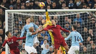 Kiper Manchester City Ederson meninju bola saat pertandingan sepak bola Liga Premier Inggris antara Manchester City melawan Liverpool di Etihad Stadium, Manchester, Inggris, Jumat (4/1). [Oli SCARFF / AFP]