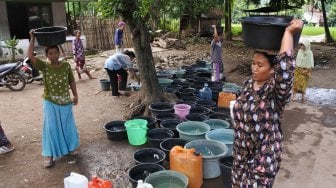 Warga membawa air bersih yang didistribusikan di Desa Sumber Tengah, Bungatan, Situbondo, Jawa Timur, Jumat (22/2).  [ANTARA FOTO/Seno]