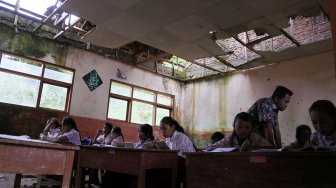 Siswa SDN Mulyorejo 05 belajar di ruang kelas yang rusak di Desa Mulyorejo, Silo, Jember, Jawa Timur, Rabu (27/2).  terakhir ini dan belum pernah ada perbaikan dari Pemerintah Kabupaten Jember. [ANTARA FOTO/Seno]