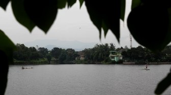 Nelayan menjaring ikan di Setu Cikaret, Cibinong, Kabupaten Bogor, Jawa Barat, Kamis (7/3). [Suara.com/Arief Hermawan P]