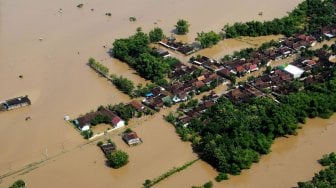 Kondisi banjir di wilayah Kabupaten Ngawi difoto dari udara dengan pesawat Helikopter NAS-332 Super Puma dari Skadron Udara 6 Lanud Atang Sanjaya Bogor yang dipiloti Mayor Pnb Nugroho Tri dan co-pilot Lettu Pnb Septian Sihombing yang sedang bertugas Bawah Kendali Operasi (BKO) di Lanud Iswahjudi, di Ngawi, Jawa Timur, Jumat (8/3). [ANTARA FOTO/Siswowidodo]