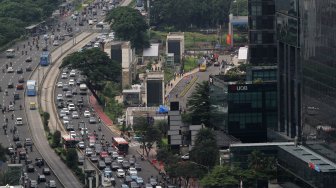 Kendaraan melintas di sekitar Bundaran Hotel Indonesia (HI), Jakarta, Selasa (12/3). [Suara.com/Arief Hermawan P.]