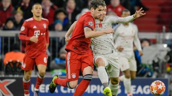 Pemain tengah Bayern Munich Javi Martinez dan pemain depan Liverpool Firmino bersaing untuk mendapatkan bola selama pertandingan leg kedua babak 16 besar Liga Champions antara Bayern Munchen melawan Liverpool di Allianz Arena, Munich, Jerman, Kamis (14/3) dini hari WIB. [SCHENFMANN GUENTER / AFP]