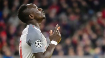 Striker Liverpool Sadio Mane merayakan golnya usai mencetak gol pembuka selama pertandingan leg kedua babak 16 besar Liga Champions antara Bayern Munchen melawan Liverpool di Allianz Arena, Munich, Jerman, Kamis (14/3) dini hari WIB. 
[SCHENFMANN GUENTER / AFP]