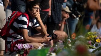 Para warga kota Christchurch meletakan bunga di dinding depan Botanical Garden, Selandia Baru, Selasa (19/3).  [Marty MELVILLE / AFP]