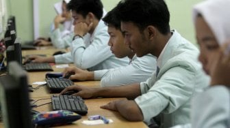 Sejumlah pelajar Sekolah Menengah Kejuruan (SMK) mengikuti Ujian Nasional Berbasis Komputer (UNBK) di SMK N 41 Jakarta, Cilandak, Jakarta (25/3). [Suara.com/Arief Hermawan P]