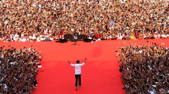 Capres nomor urut 01 Joko Widodo menyapa pendukung saat kampanye akbar bertajuk "Konser Putih Bersatu" di Jakarta, Sabtu (13/4).[Suara.com/Arief Hermawan P]