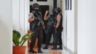 Personel Polres Tasikmalaya Kota berjaga saat petugas Komisi Pemberantas Korupsi (KPK) melakukan penggeledahan ruang kerja Walikota Tasikmalaya Budi Budiman di Bale Kota Tasikmalaya, Jawa Barat, Rabu (24/4). [ANTARA FOTO/Adeng Bustomi]
