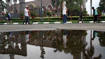 Warga beraktifitas di sekitar Masjid Dian Al Mahri atau yang dikenal dengan Masjid Kubah Emas di Depok, Jawa Barat, Minggu (12/5). [Suara.com/Arief Hermawan P]