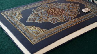 Al Quran berukuran mini yang ditulis dengan tinta emas di Masjid Jami Daarussalaam, Pasir Jambu, Kabupaten Bogor, Jawa Barat, Senin (13/5). [Suara.com/Arief Hermawan P]