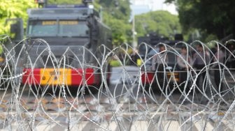 Pengamanan kawat berduri melintang sepanjang jalan Imam Bonjol di depan Gedung KPU Pusat, Jakarta, Selasa (21/5). [Suara.com/Muhaimin A Untung]